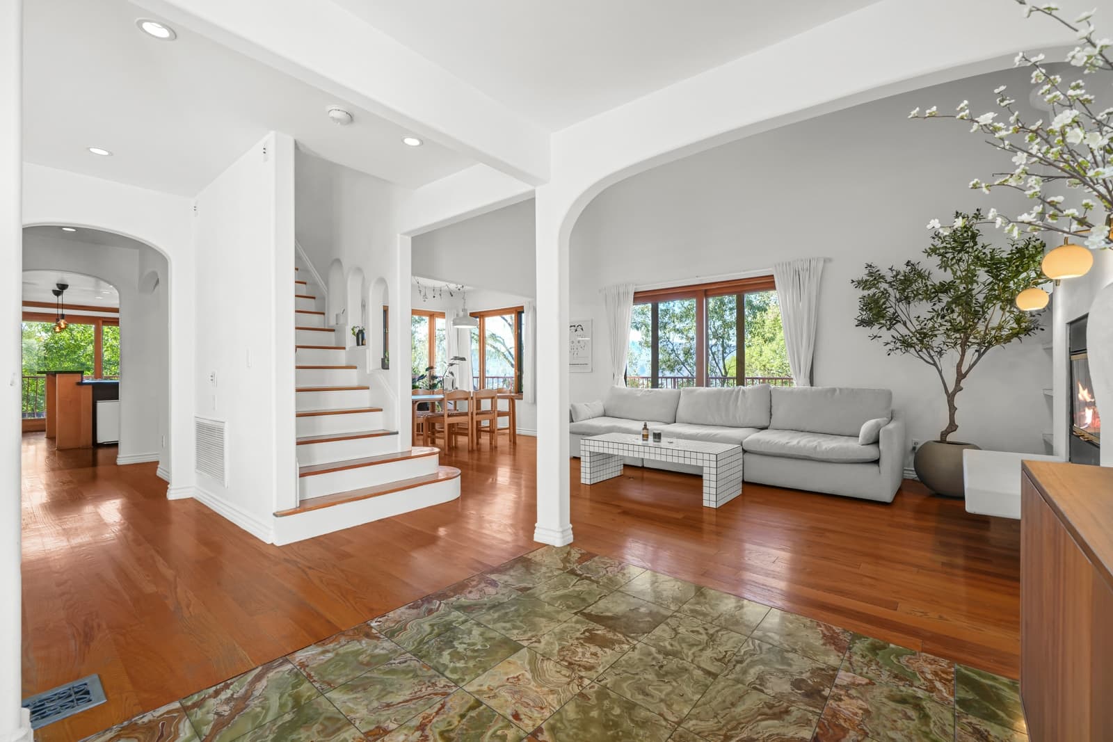 Living room with arched French doors and oak floors
