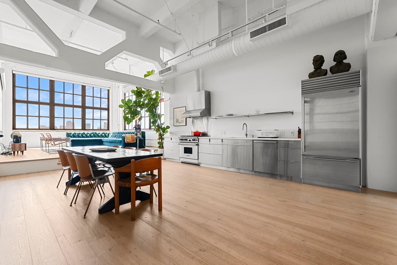 Loft kitchen and dining under steel-frame windows