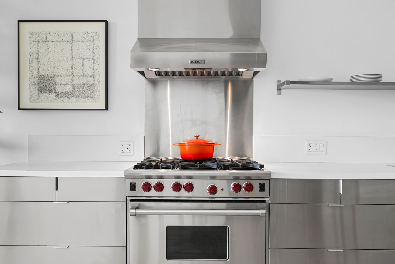 Steel range and hood with a red Dutch oven
