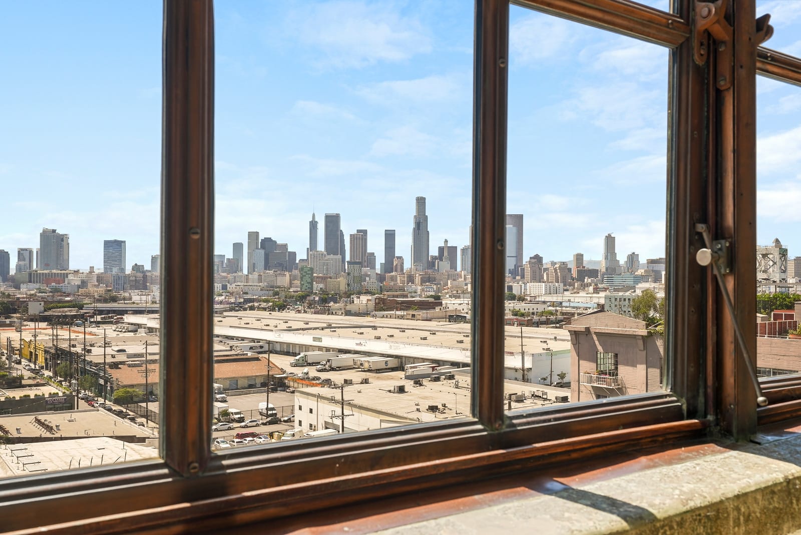 Steel loft window framing the downtown skyline