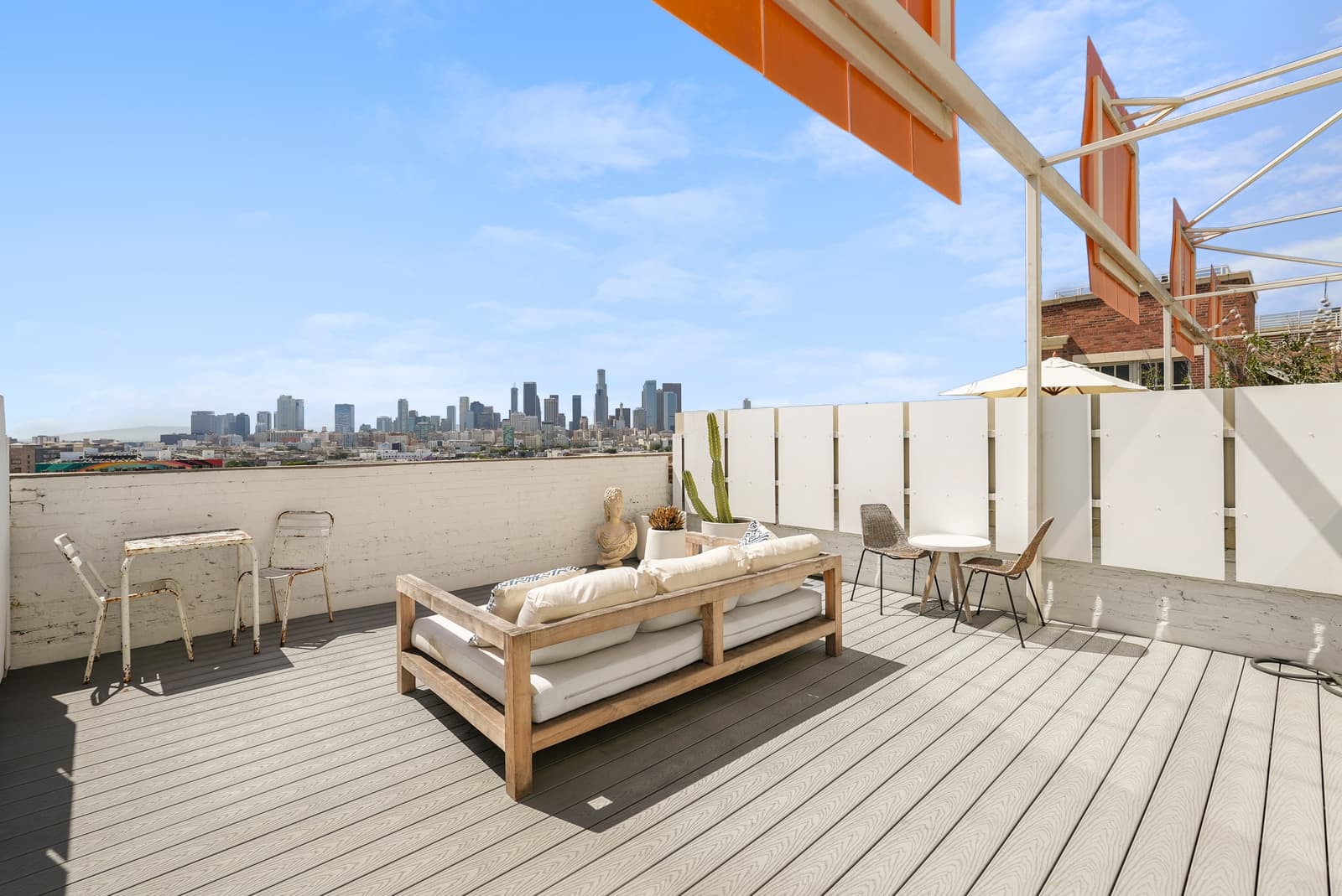 Private roof deck with a daybed and the downtown skyline