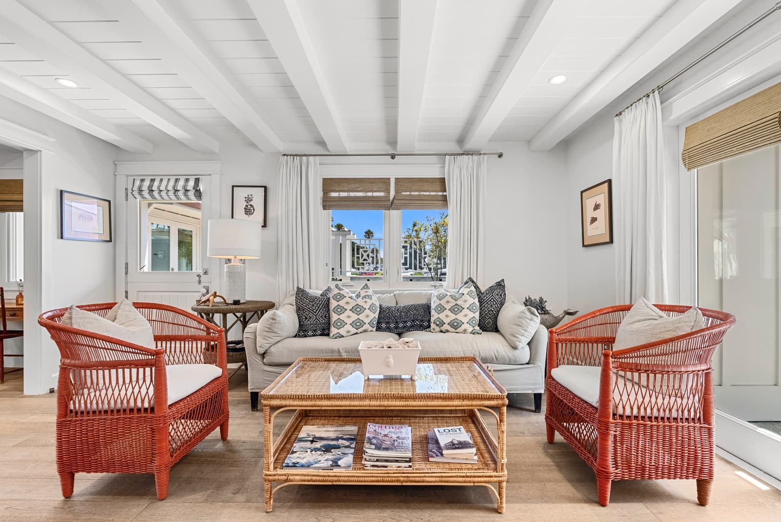 Beach cottage living room, red rattan chairs, white beams