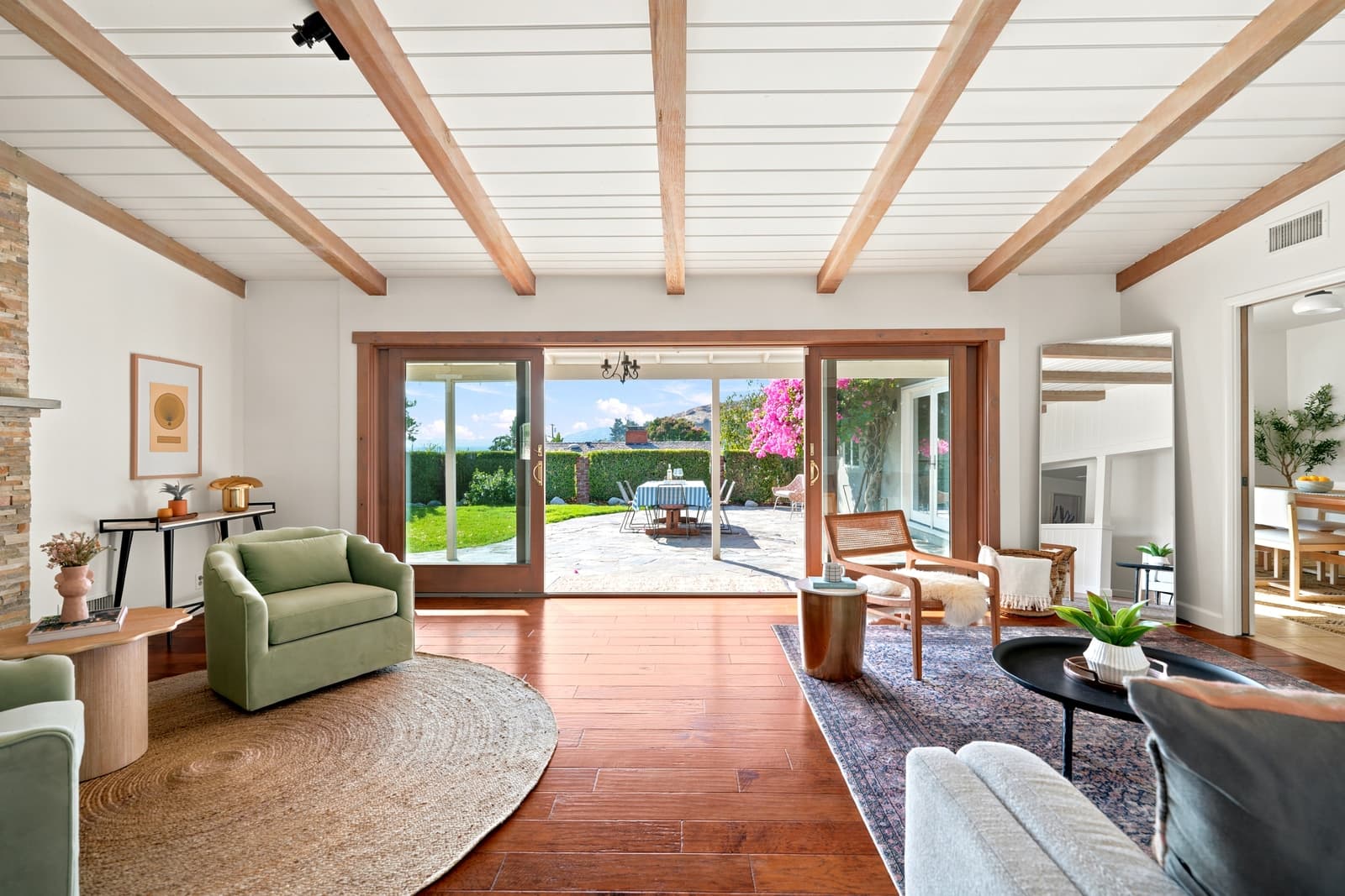 Beamed living room open to the lawn