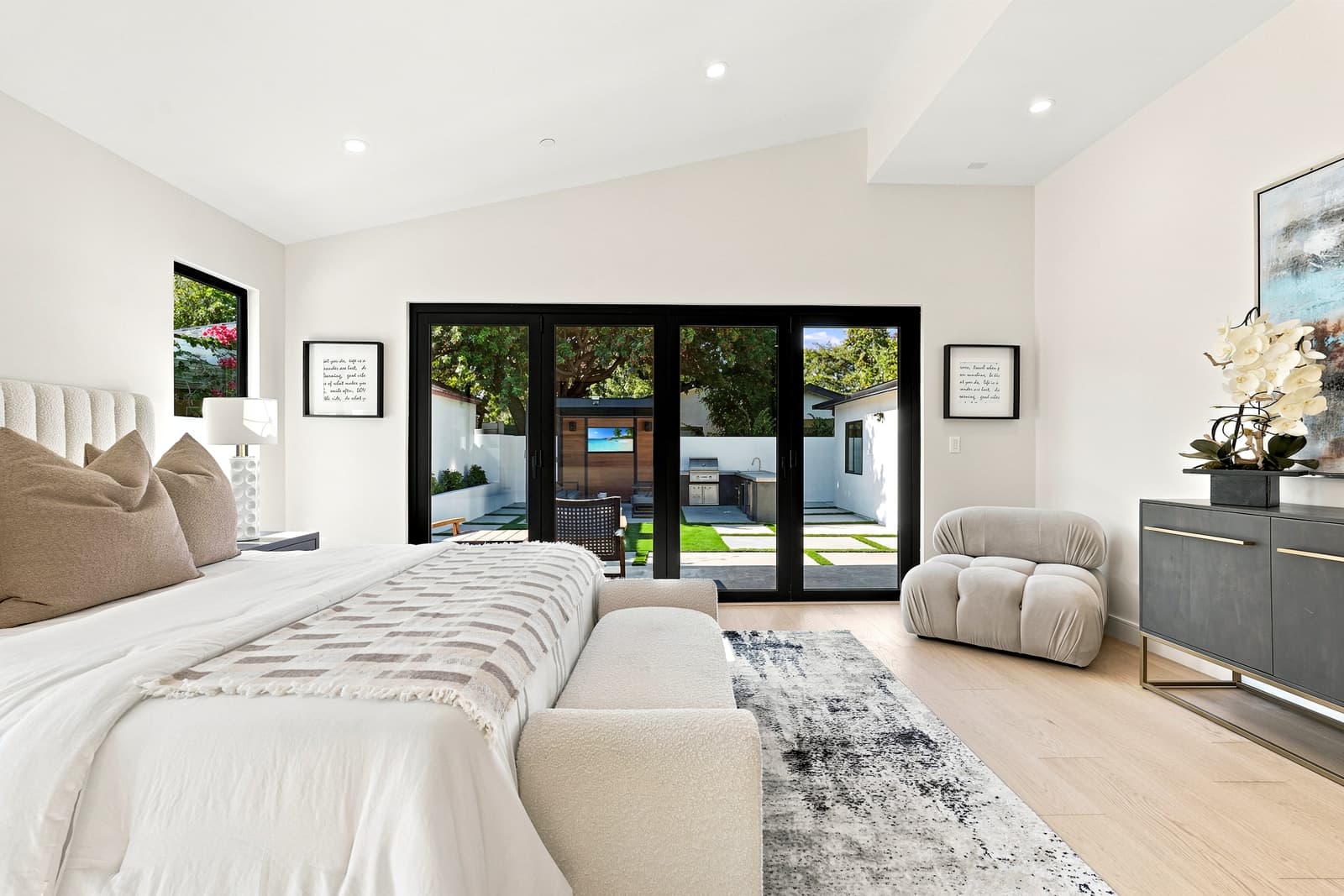Bedroom with doors opening to the yard, the kind of room buyers walk in a 3D tour