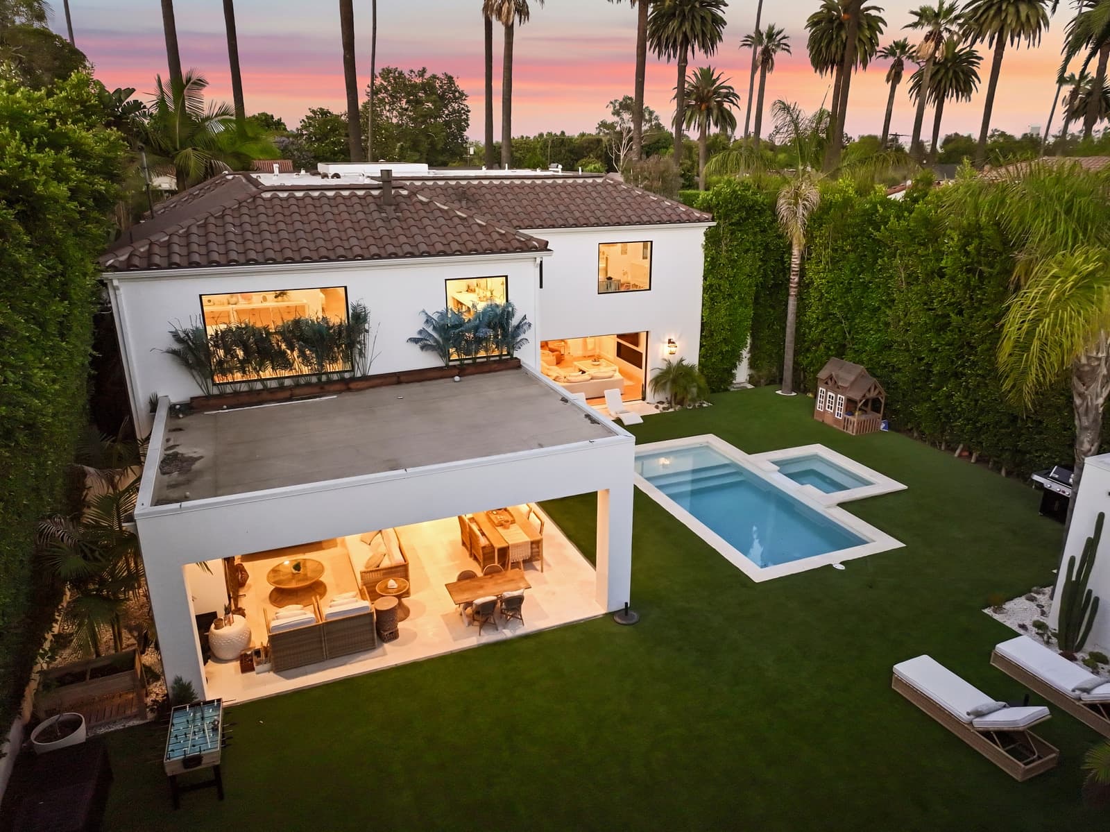 Drone view of a Beverly Hills rear yard, pool and covered patio
