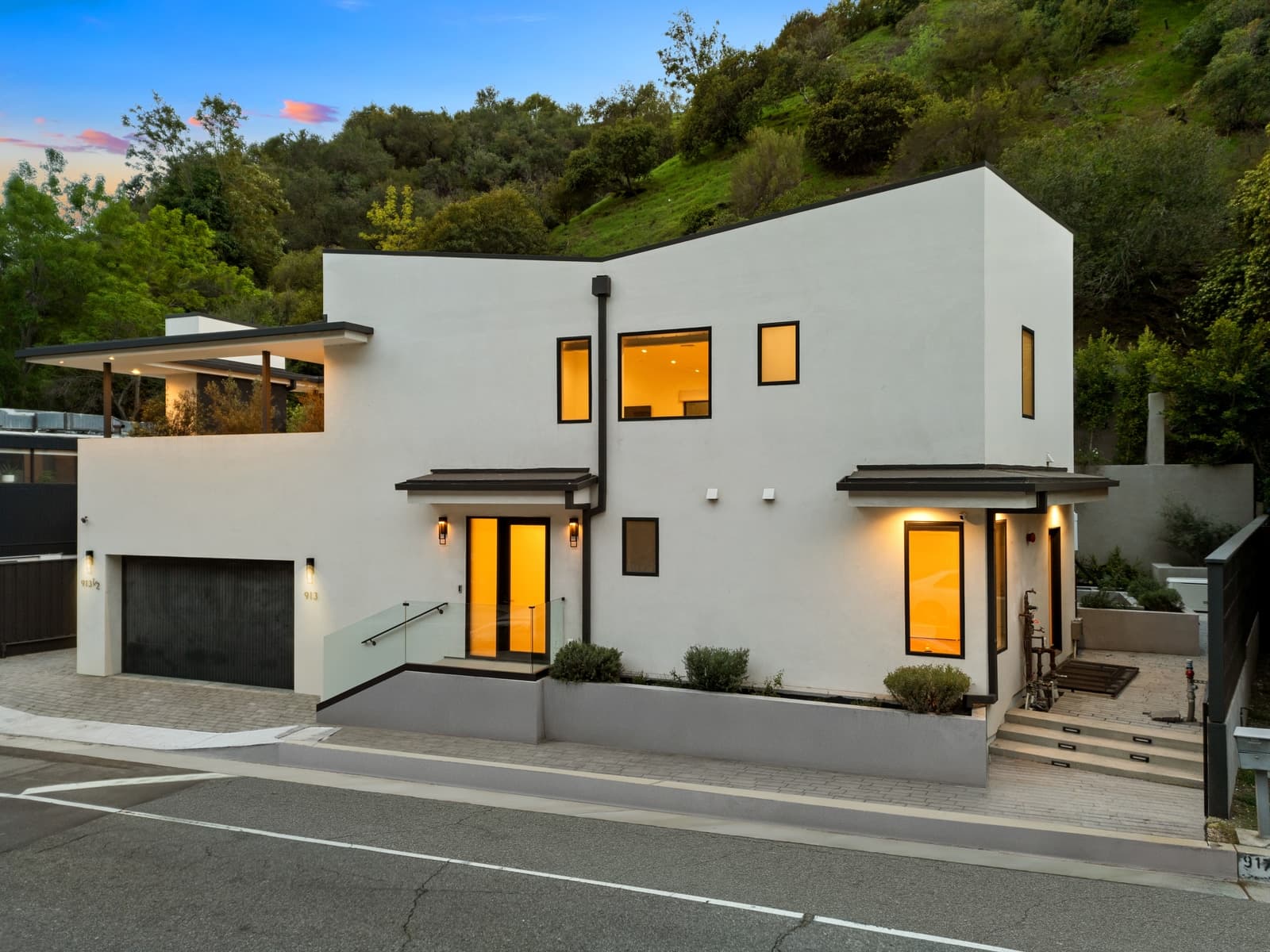 New Beverly Hills modern at twilight, windows glowing