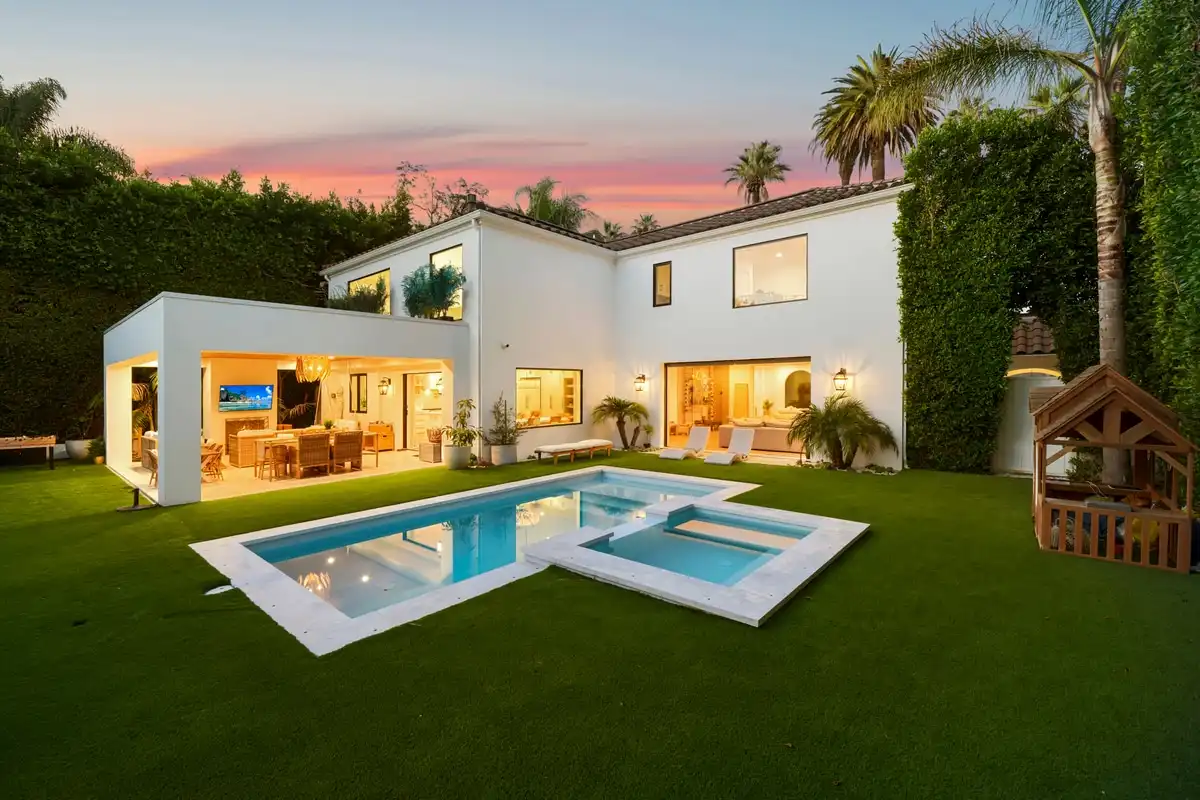 Rear of a Beverly Hills home at twilight, pool and spa