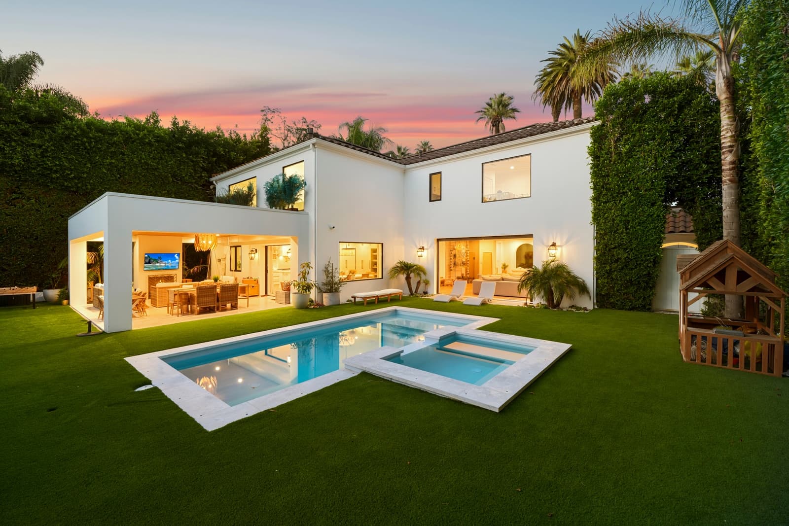 Rear of a Beverly Hills home at twilight, pool and spa