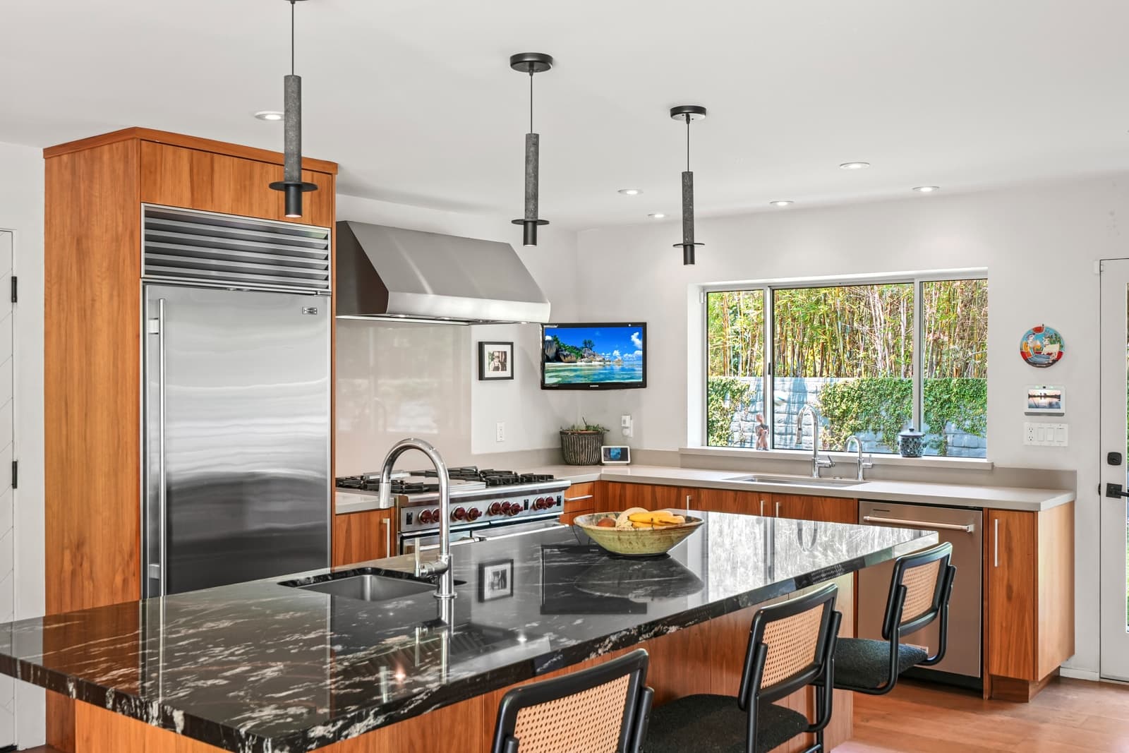 Kitchen with a black marble island and a stainless range