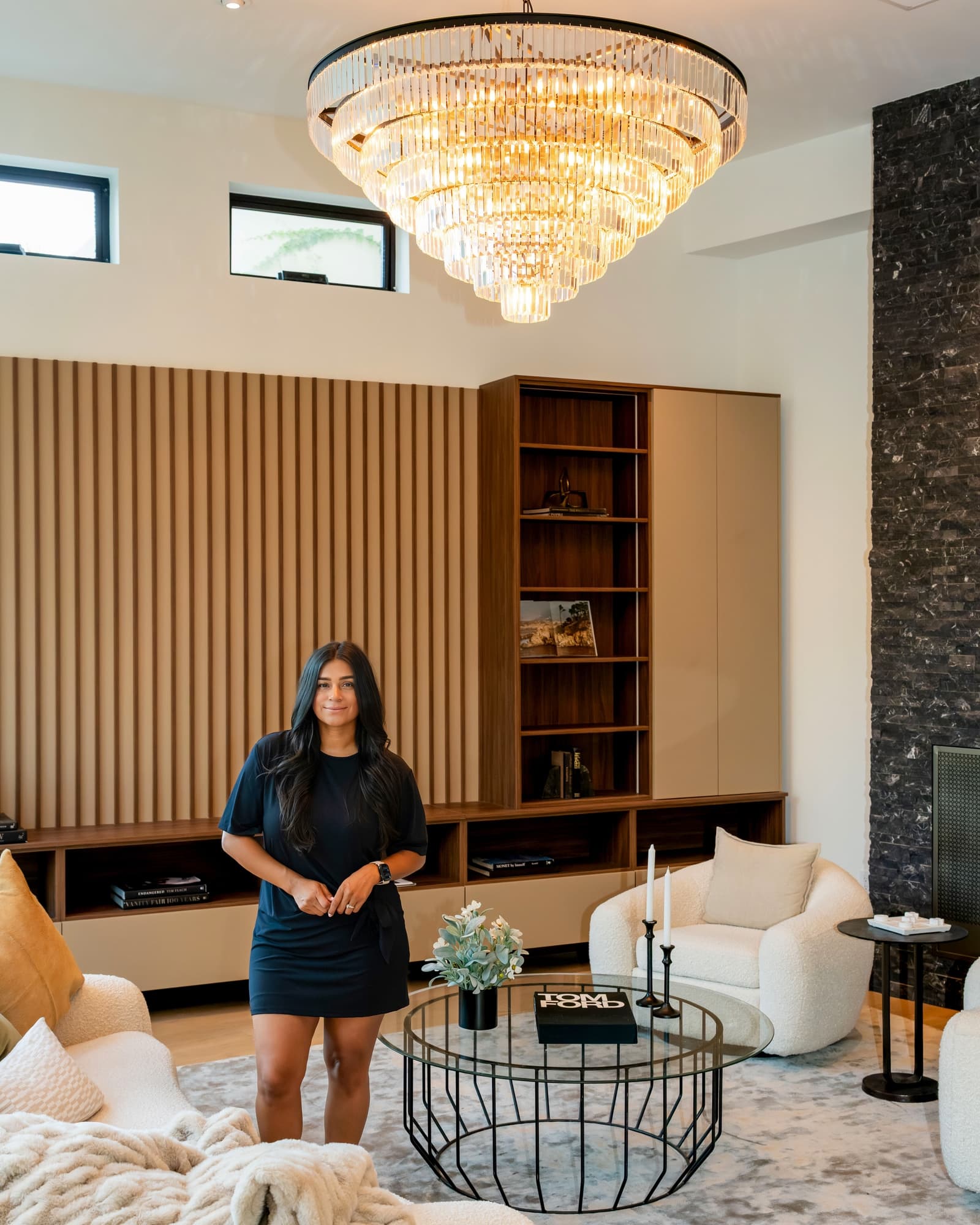 Agent seated beneath a crystal chandelier