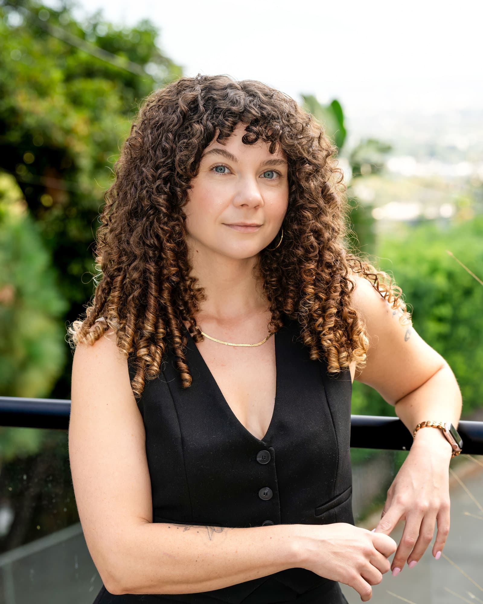 Agent portrait on a balcony with a city view