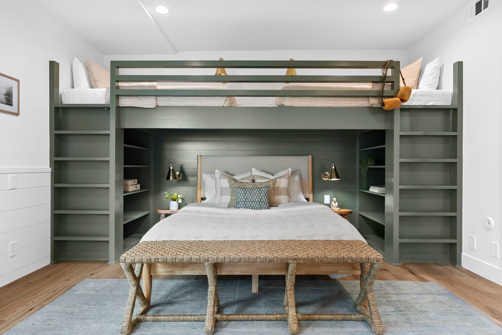 Built-in bunk bed in a green millwork wall