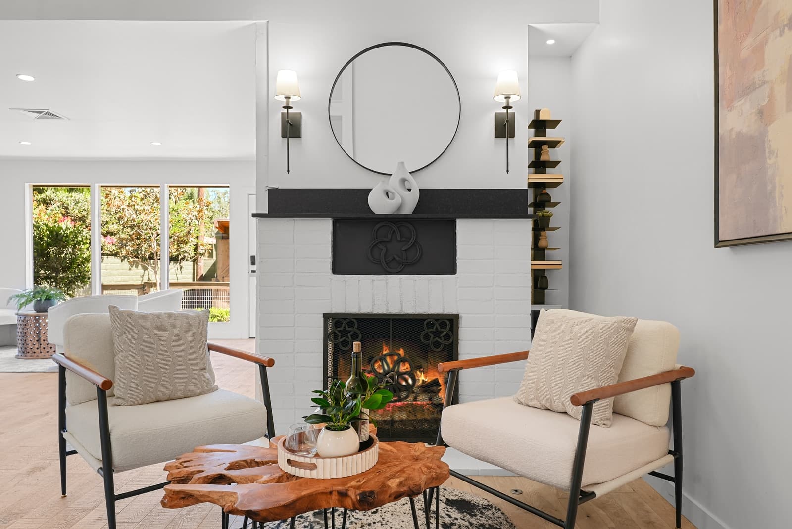 Living room with a black fireplace and round mirror, Burbank