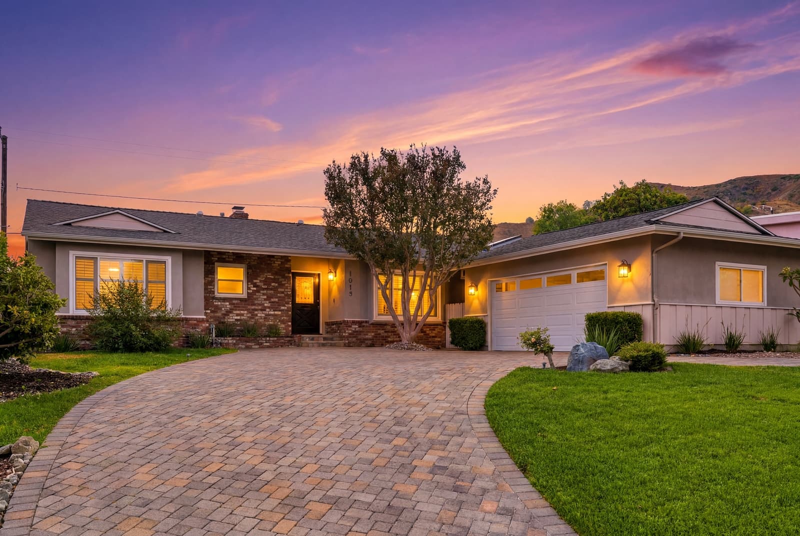 Burbank ranch at twilight, brick drive and bougainvillea