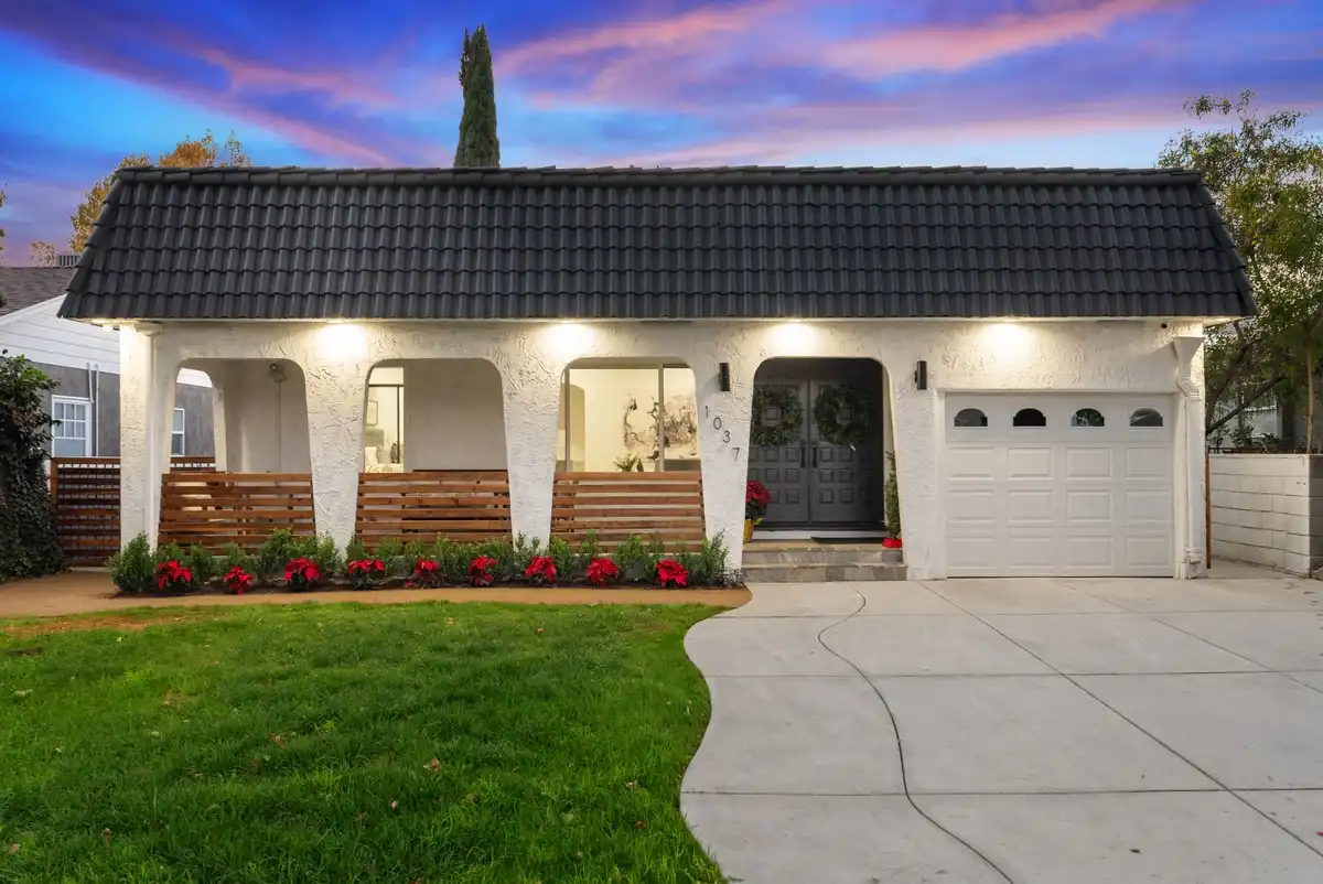 Spanish single-story at twilight, arches lit across the lawn, Burbank