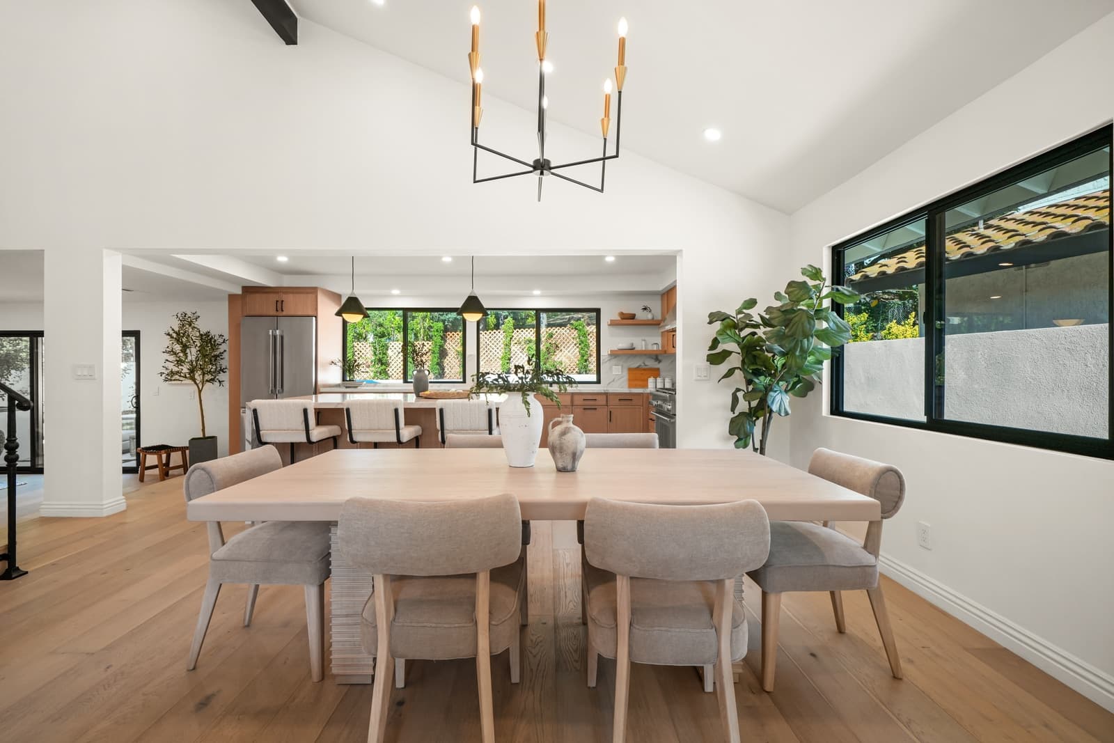 Dining room with a brass chandelier over an oak table