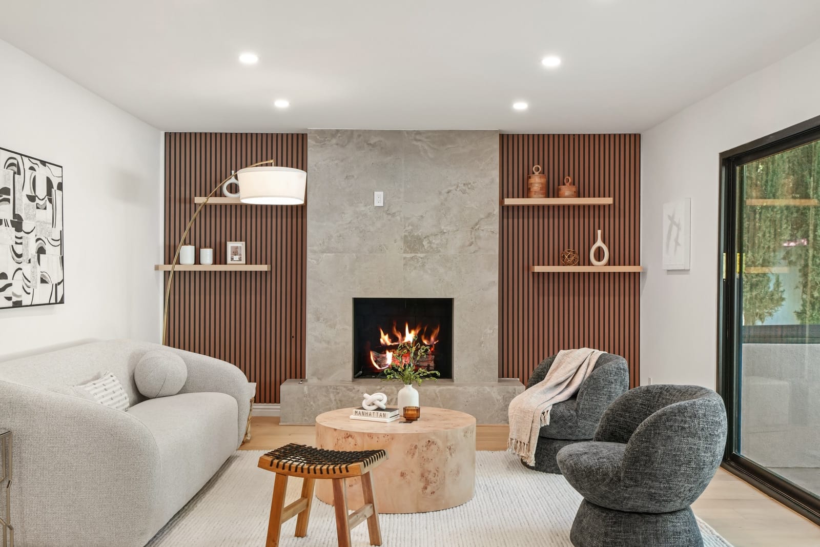 Stone fireplace between slatted wood walls, seen straight on