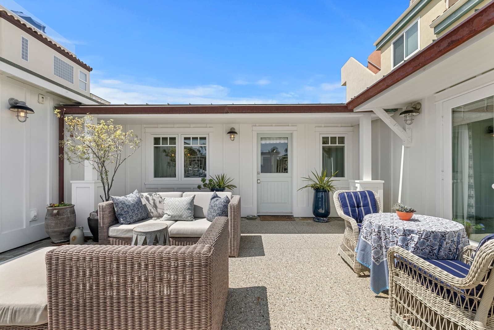 Courtyard lounge with rattan seating and blue cushions