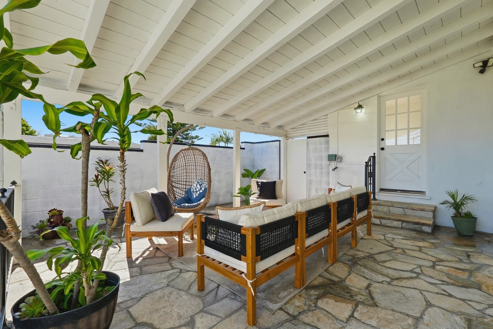 Covered flagstone patio with a hanging chair