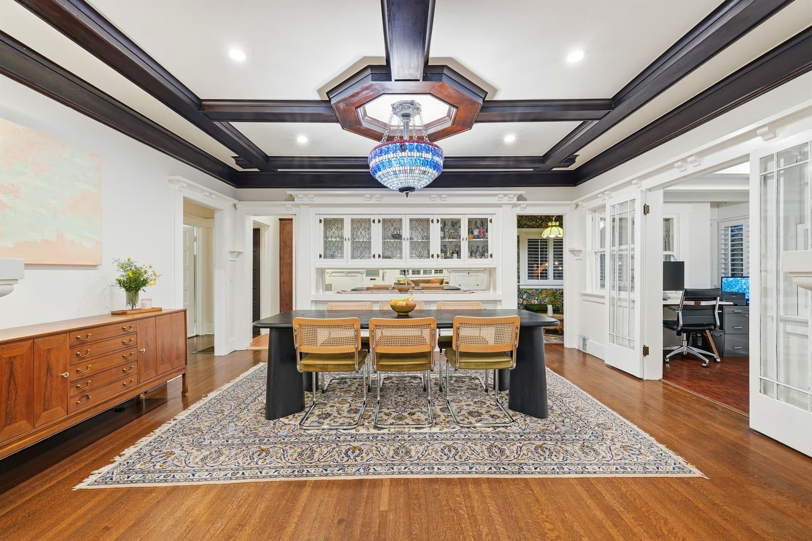 A Craftsman dining room lit through original stained glass.