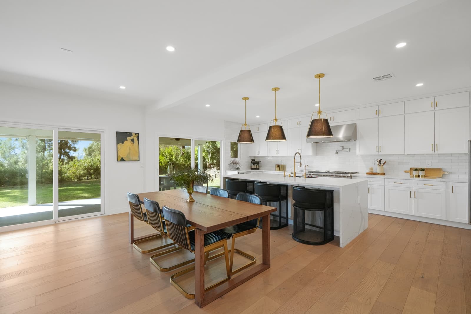 Dining and kitchen under black pendants