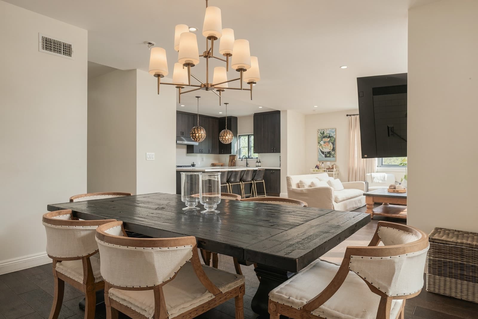 Dining room with a black wood table and a linen-shade chandelier