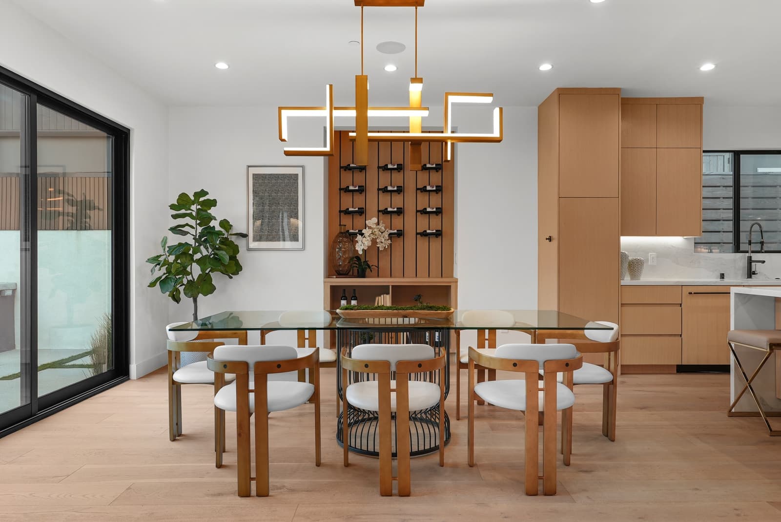 Dining room with an oak table and a modern chandelier
