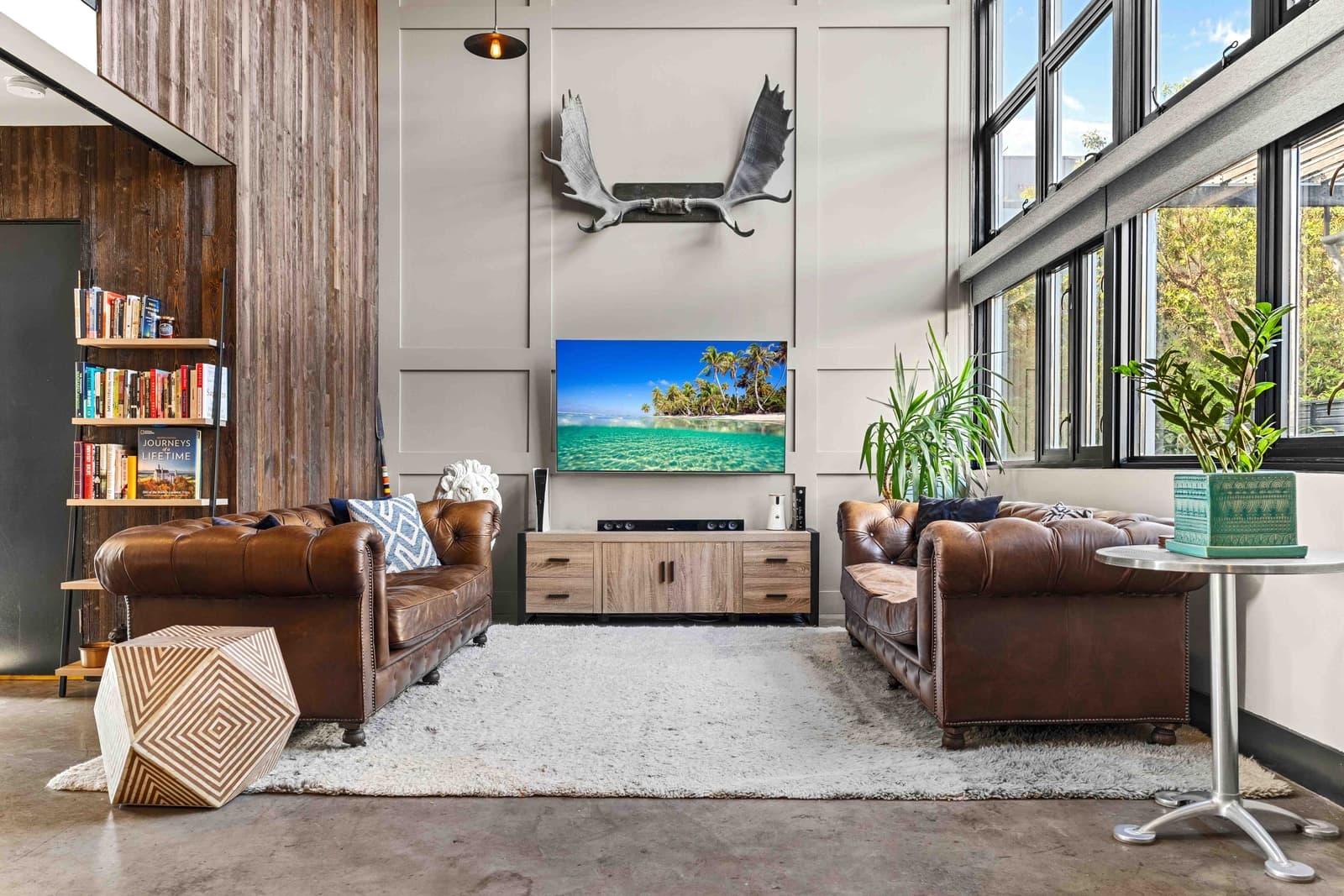 Double-height living space with floor-to-ceiling glazing, architectural composition
