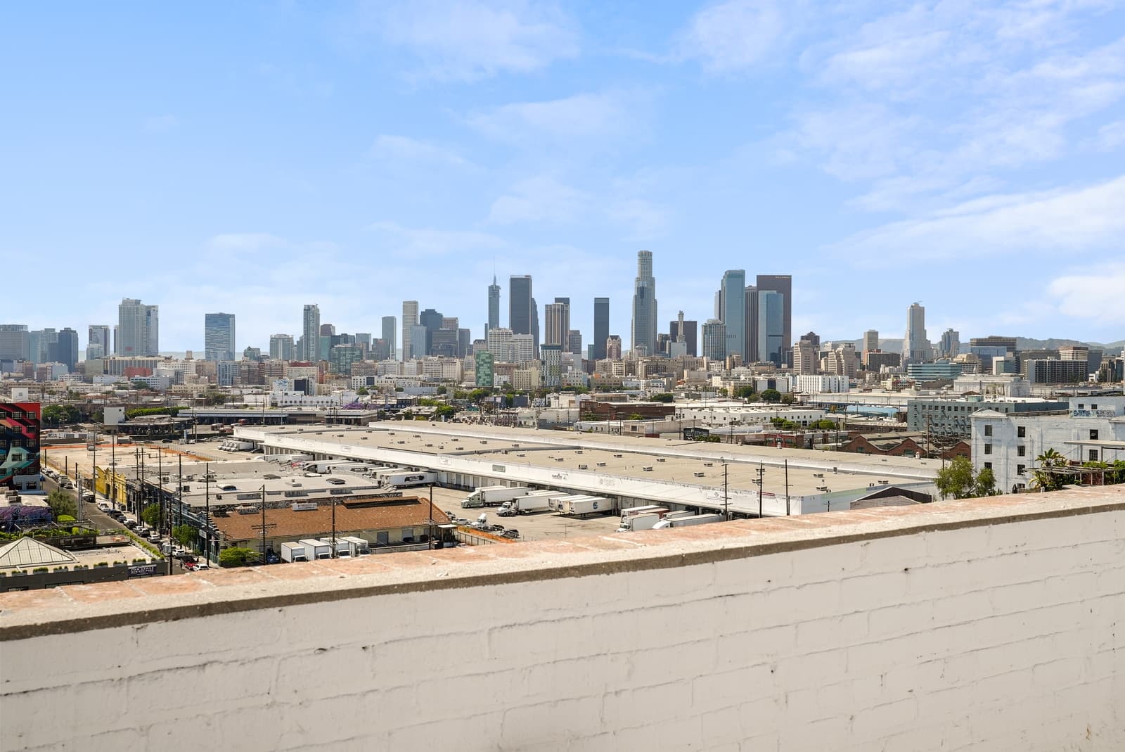 Downtown Los Angeles skyline from a rooftop, freeway below