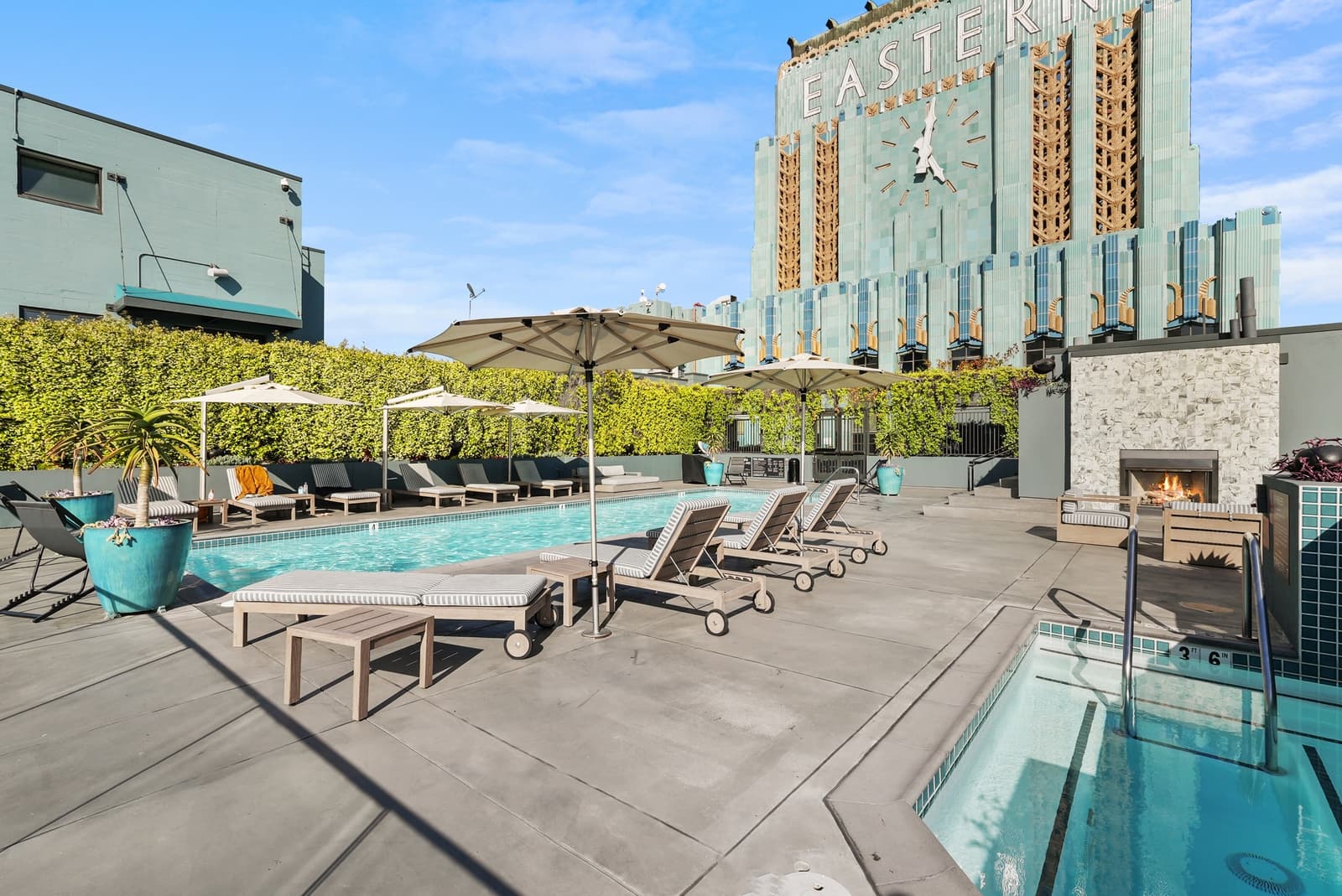 Rooftop pool beneath the turquoise clock tower of the Eastern Columbia Building