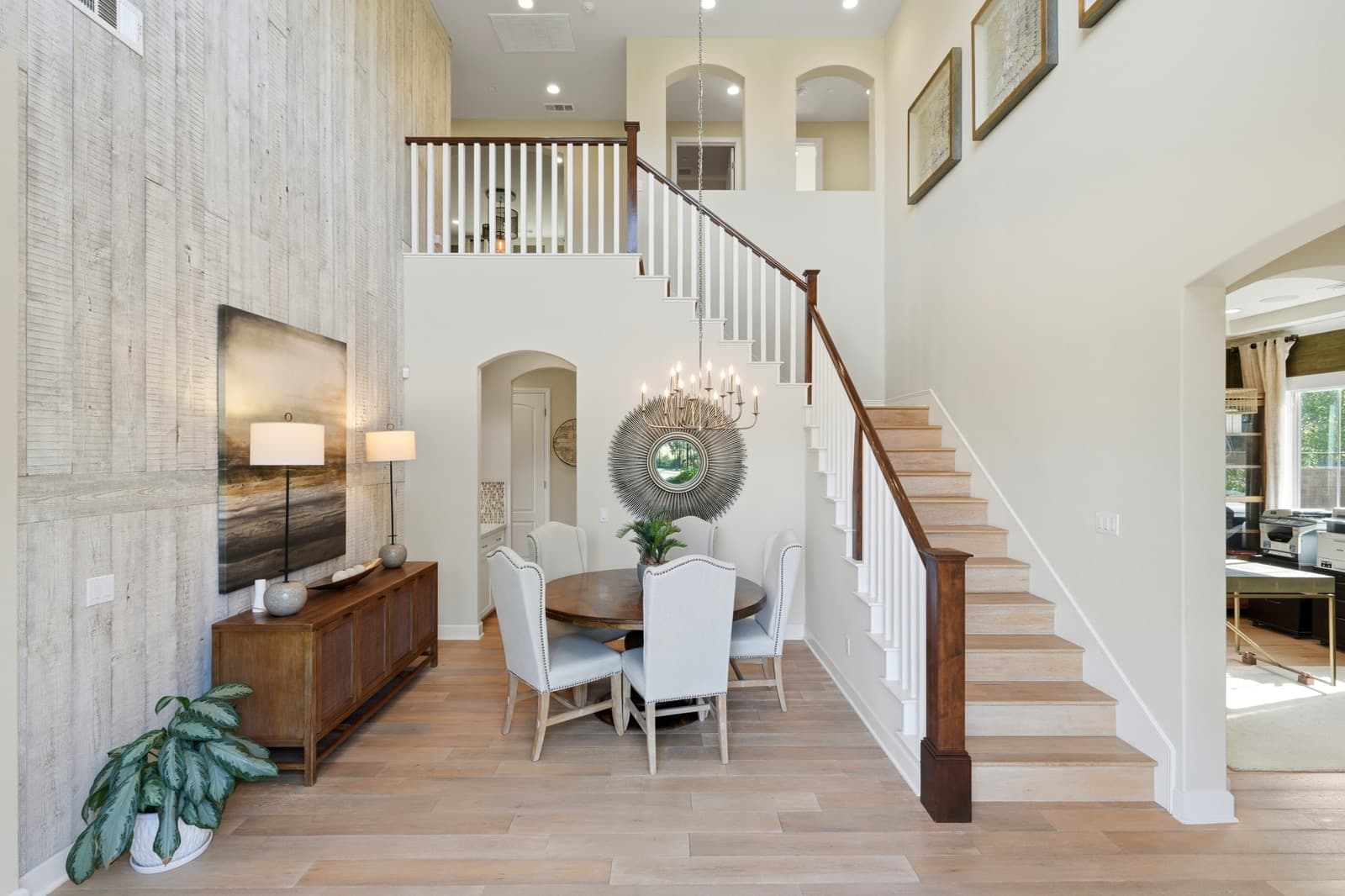 Two-story entry with a staircase opening onto the dining room