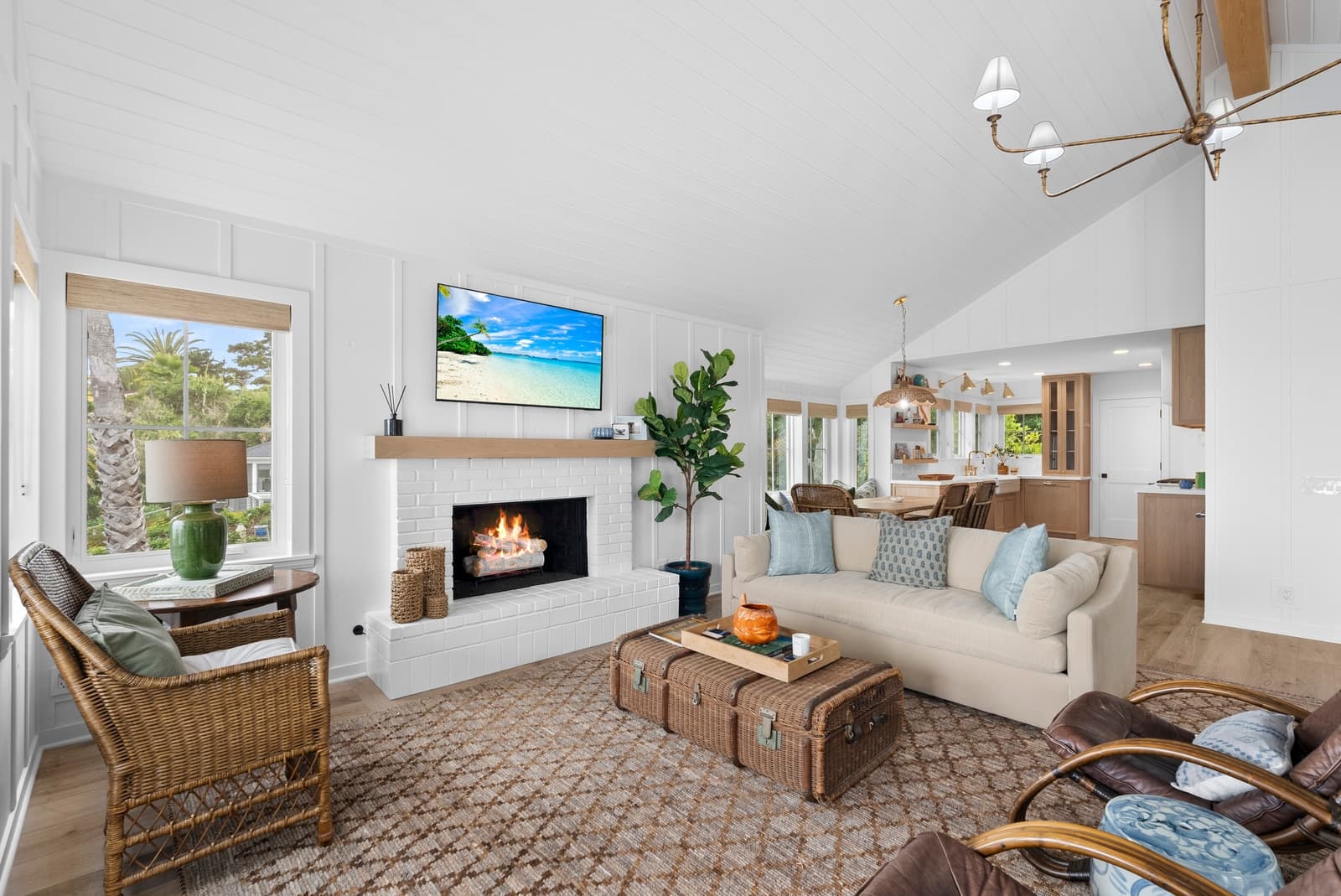 Farmhouse living room toward the kitchen, fire lit