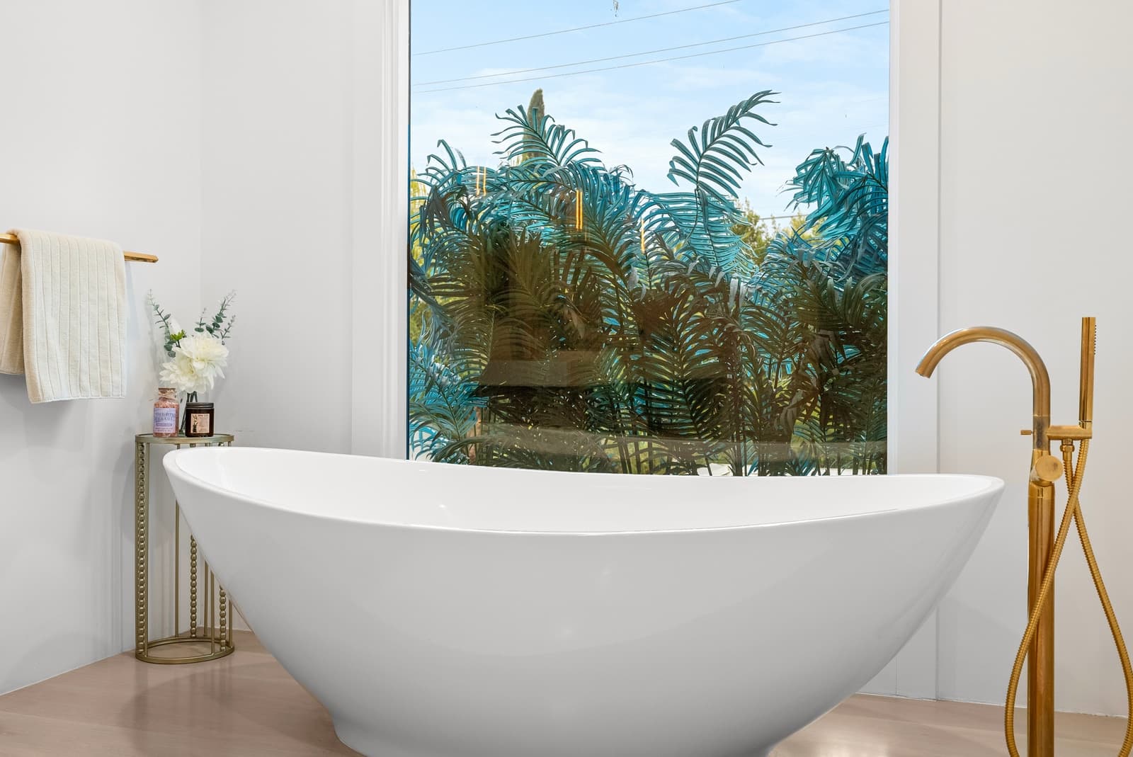 Freestanding tub beneath a garden window