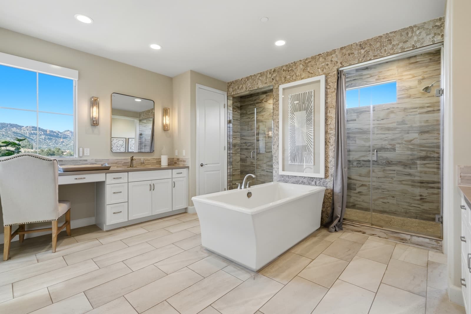 Freestanding tub beside a stone-tiled shower wall