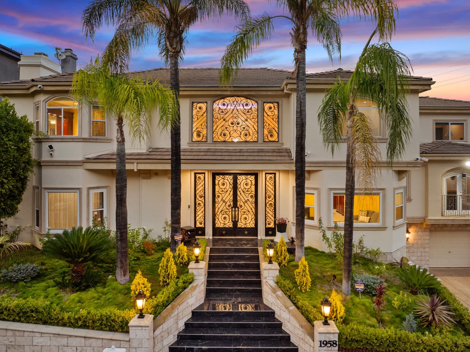 Hillside estate at twilight, iron doors lit, Glendale