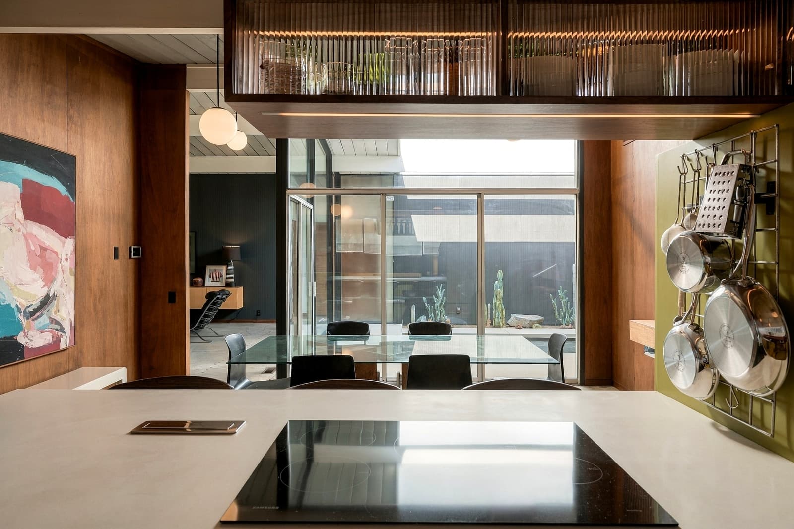 Kitchen island with walnut stools, opening to the dining room