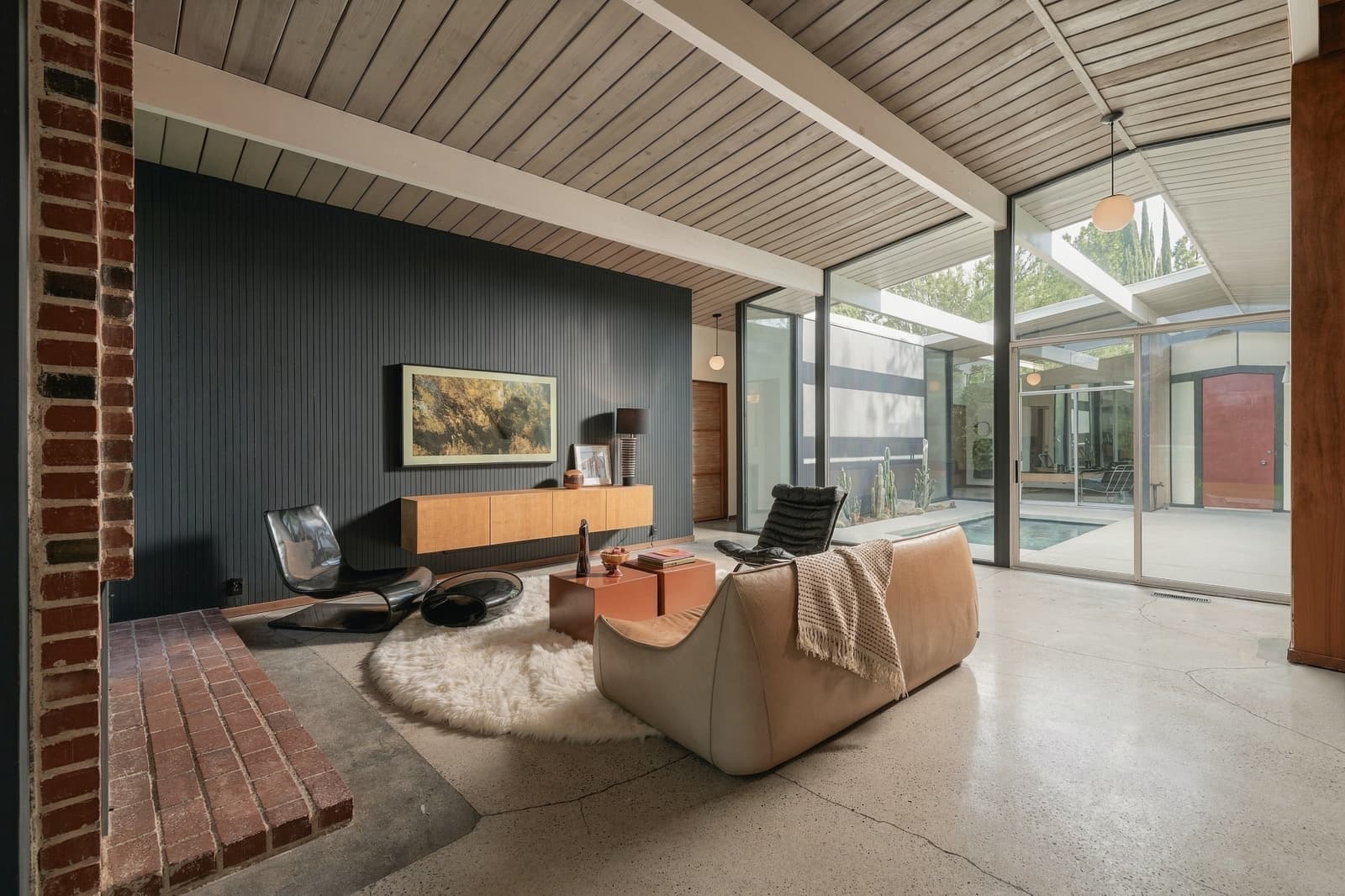 Living room looking through glass to the atrium pool beyond