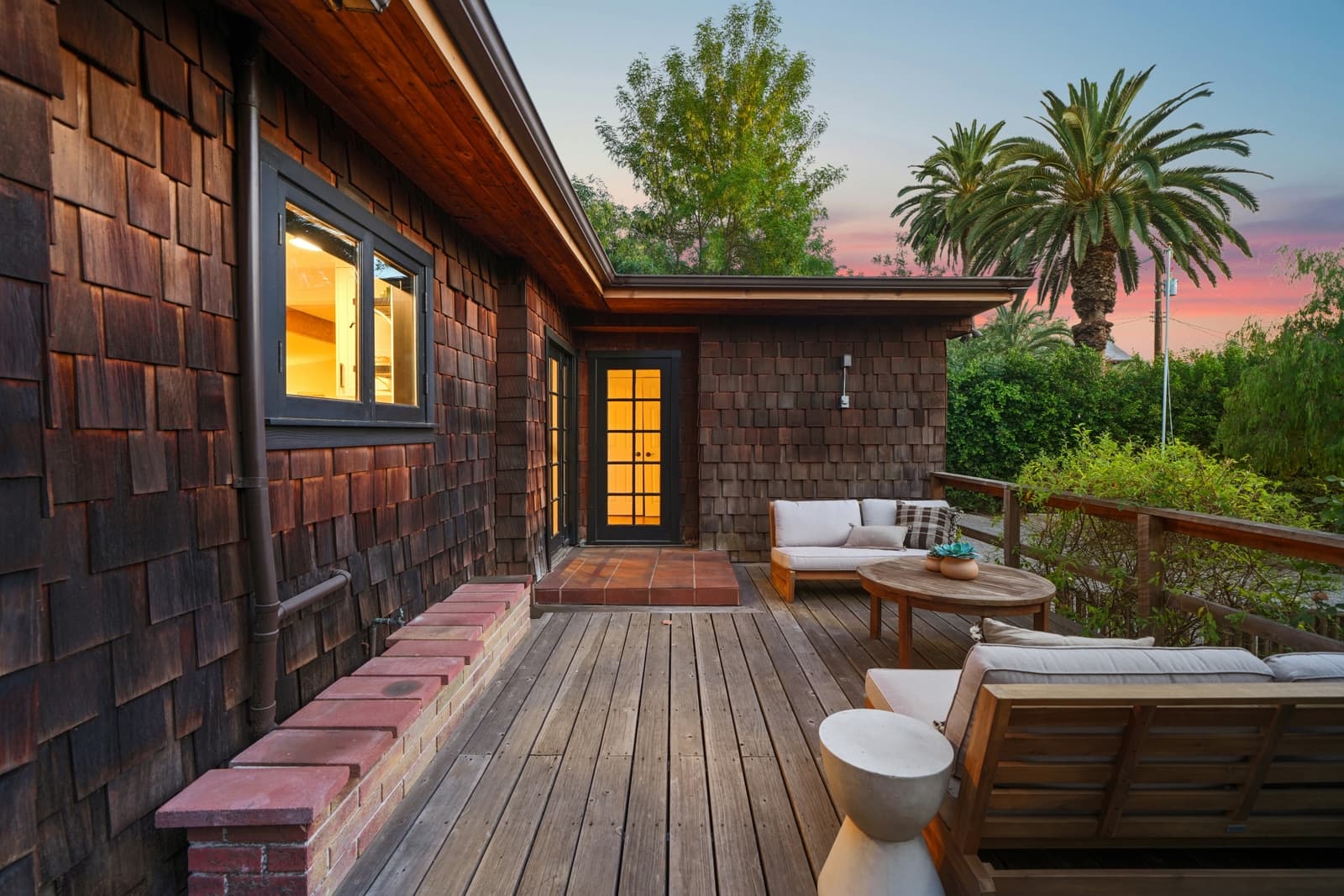 Deck with a sofa and a palm at twilight, Highland Park