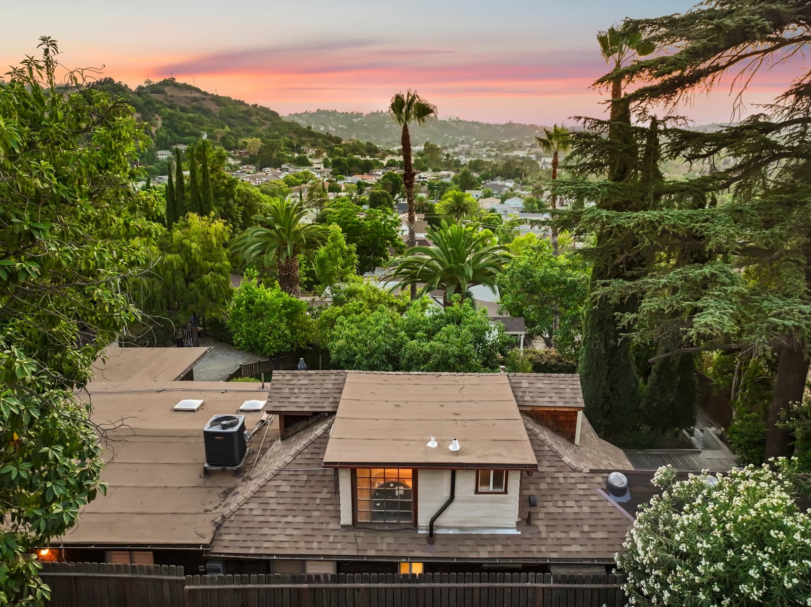 Drone over a shingled roof at sunset, Highland Park