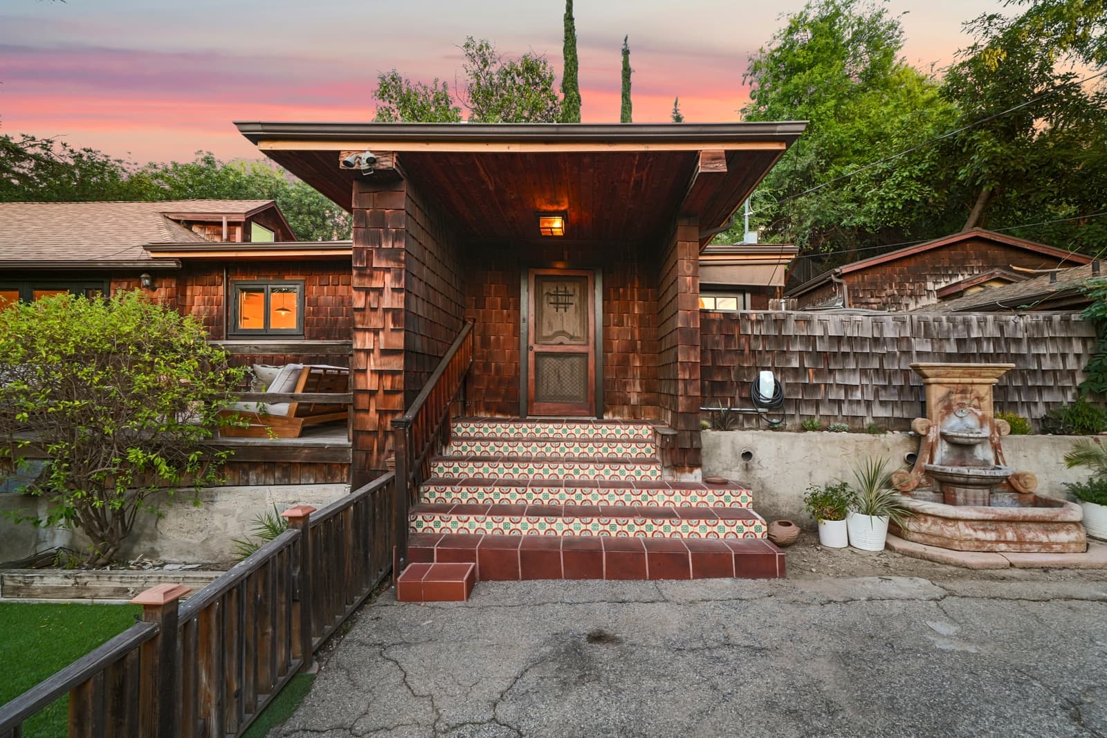 A tiled entry porch in Highland Park glowing at twilight.