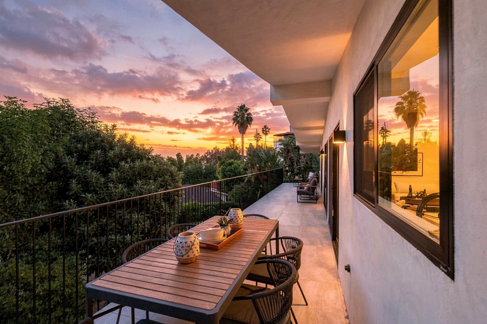 Balcony dining table at sunset, the sky mirrored in the glass, Hollywood Hills