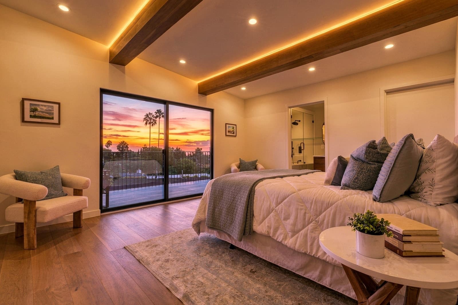 Bedroom at sunset under a wood beam, sliders open to the view