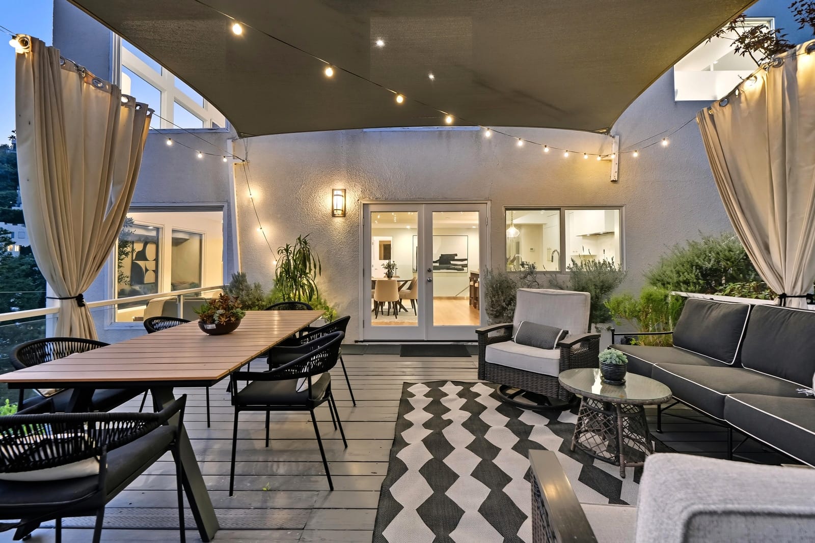 Covered deck under string lights at dusk