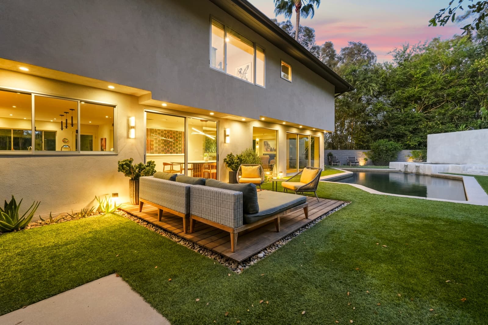 Outdoor sofa on a deck at dusk, pool beyond, Hollywood Hills