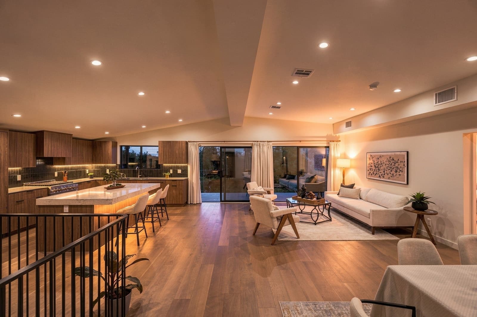 Open living room and kitchen at twilight, sunset through the sliders