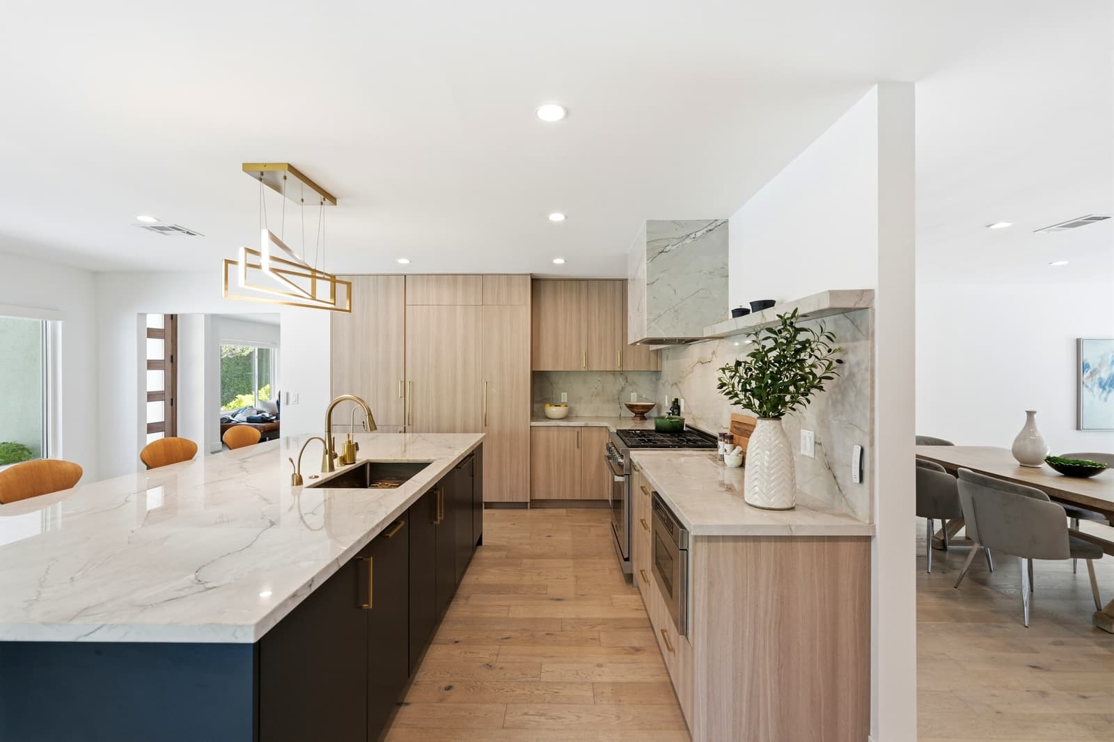 Kitchen with a marble backsplash and light oak cabinets