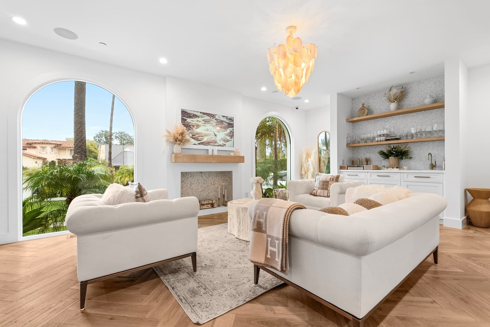 Living room with arched windows and a fireplace