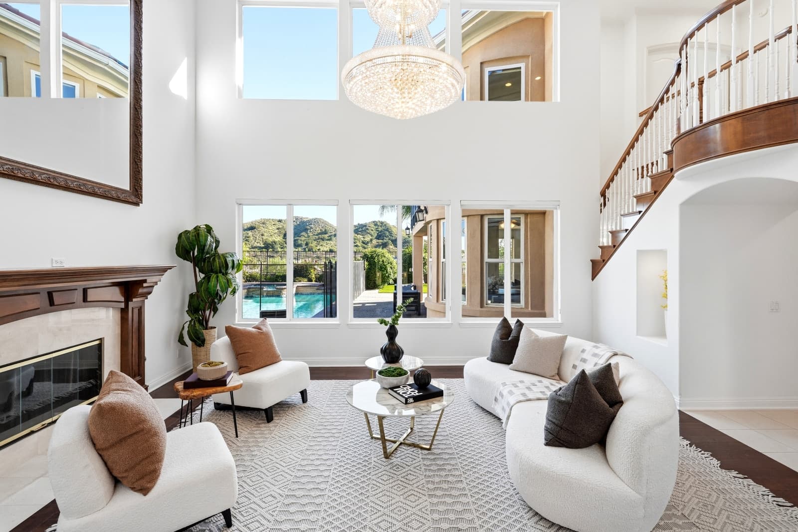 Living room with a chandelier and a view to the pool, framed for a walkthrough video