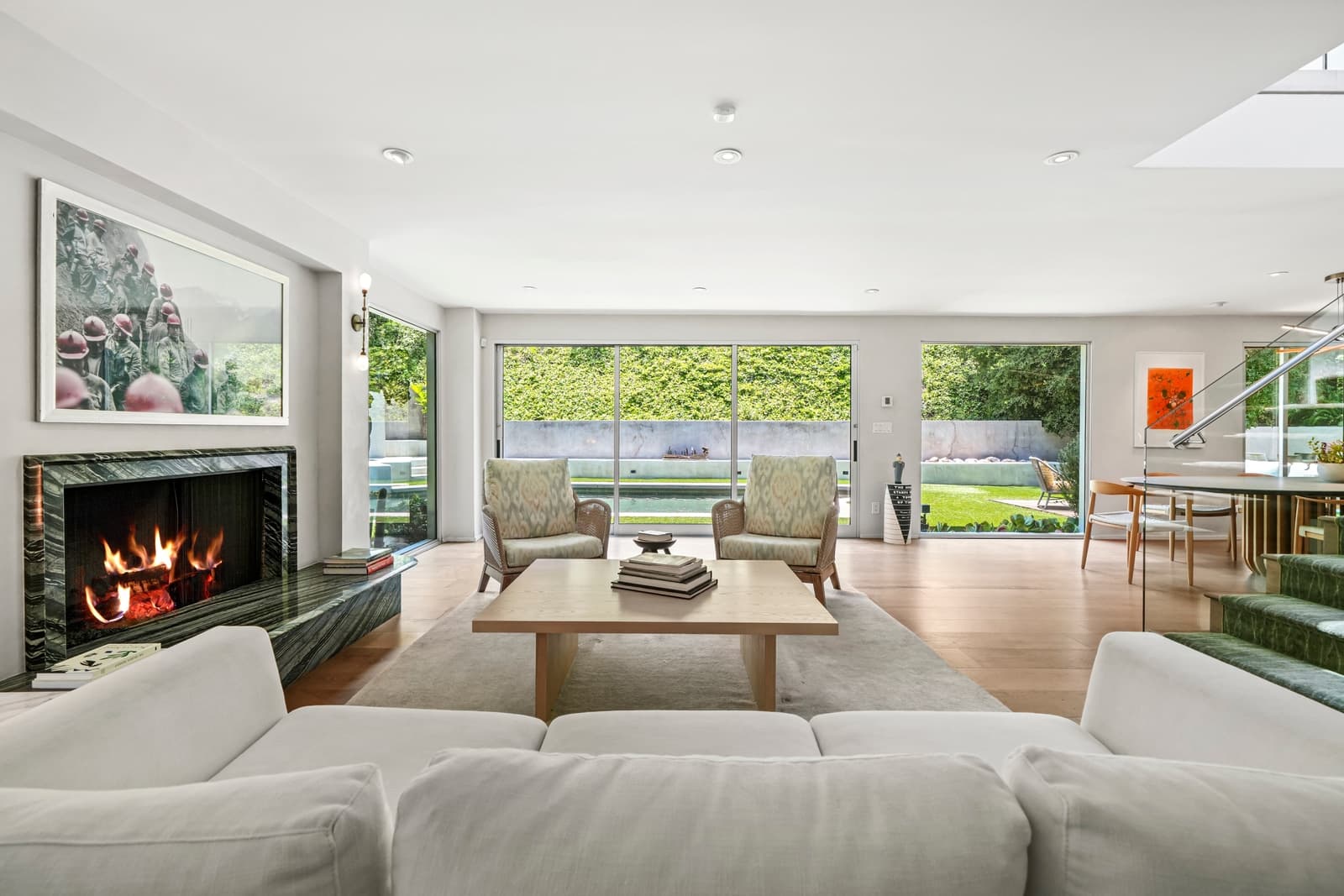 Living room with the fire lit and sliders open to the pool