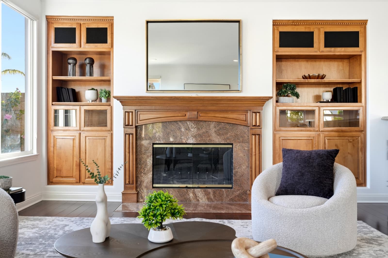 Living room with a fireplace flanked by built-ins